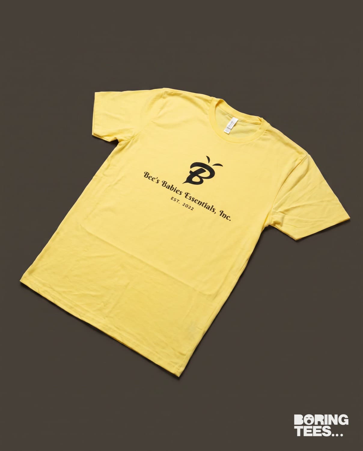 Yellow tee with a black Bee's Babies Essentials bee logo printed centre chest