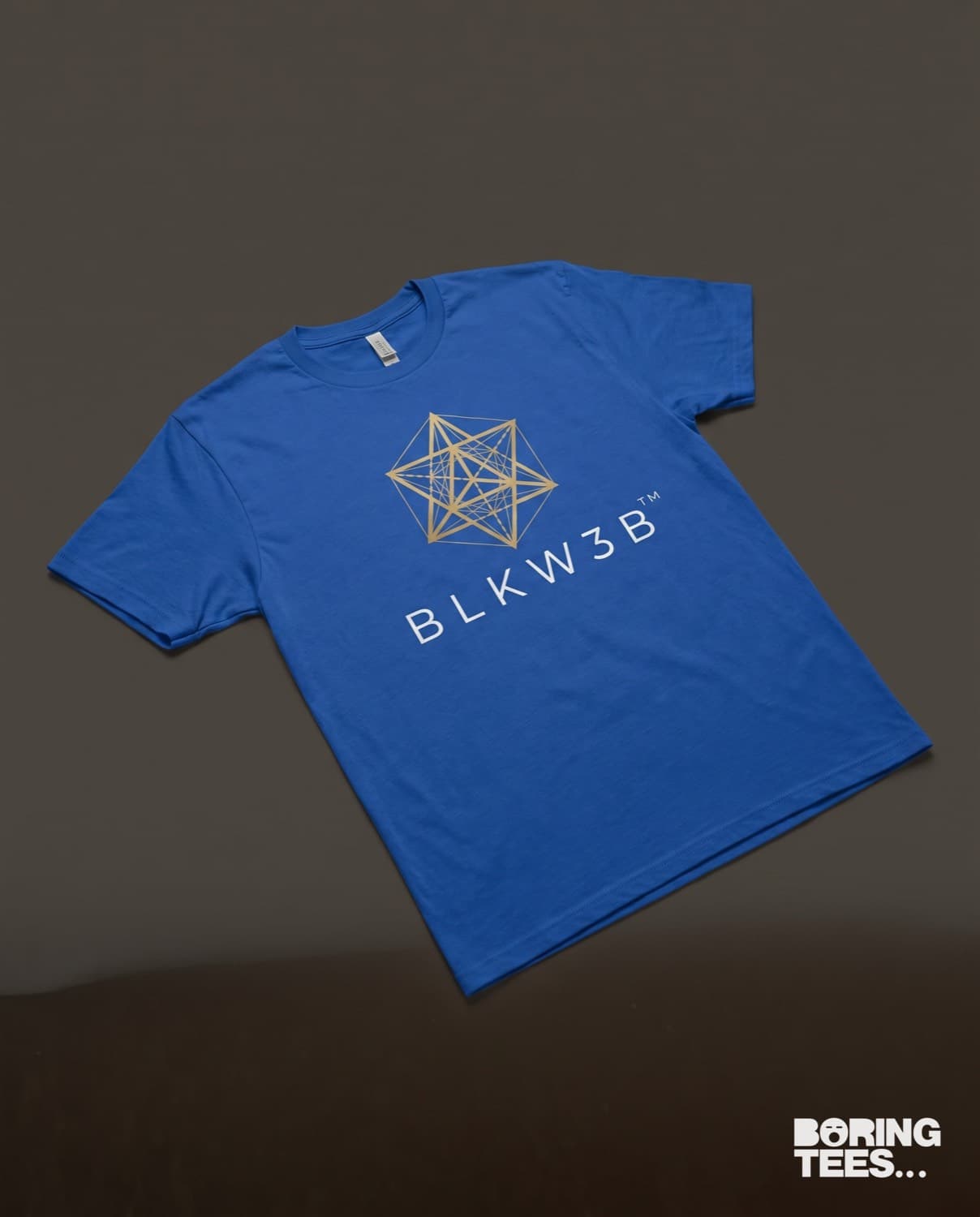 Royal blue tee with a gold geometric BLKW3B mark above a white wordmark