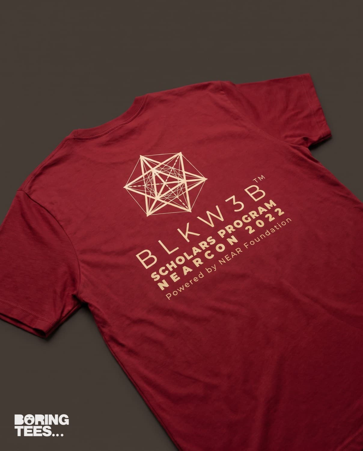Cardinal red tee with a cream BLKW3B Scholars Program NEARCON 2022 print