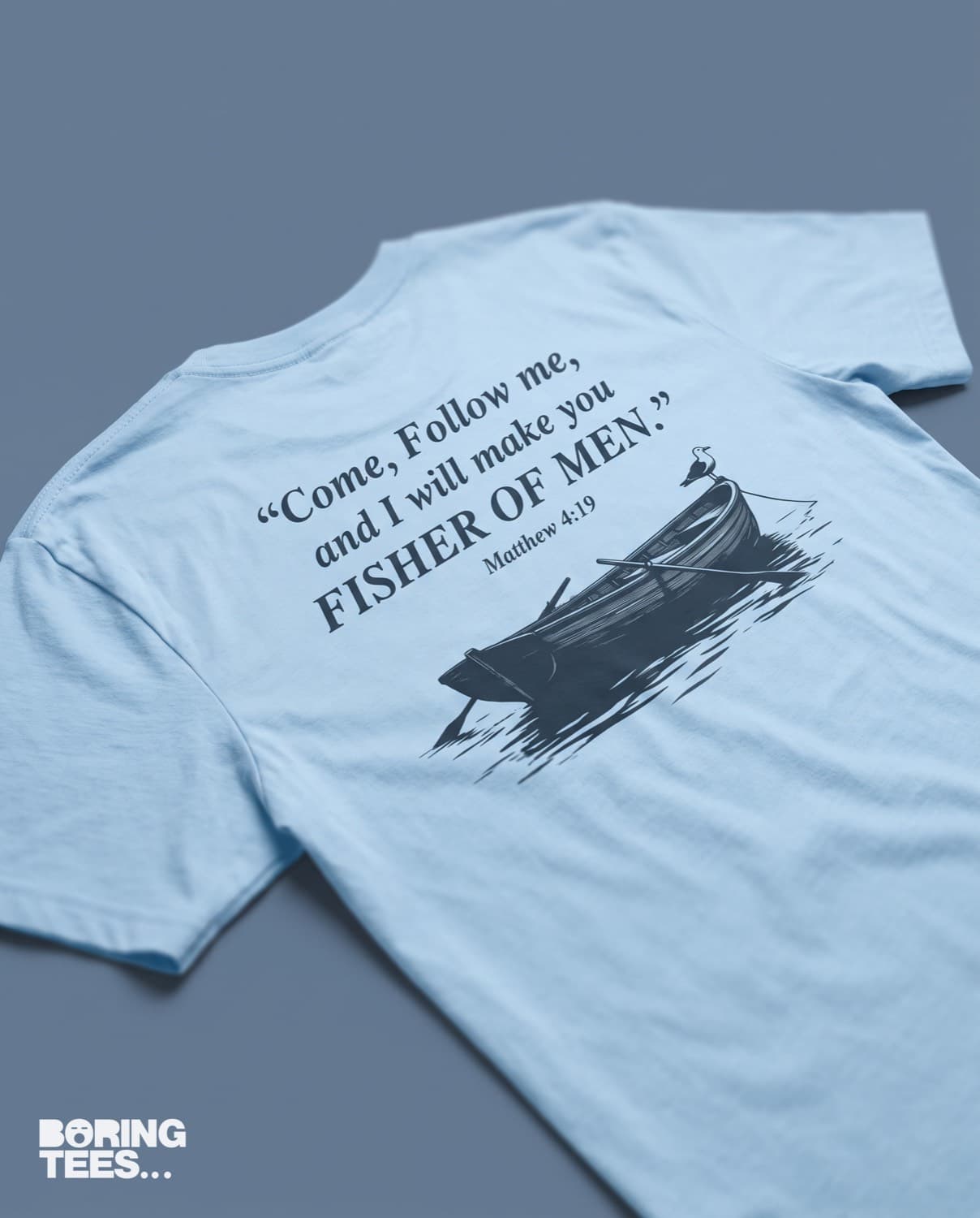 Light blue tee with a navy back print of a rowing boat and the Matthew 4:19 verse