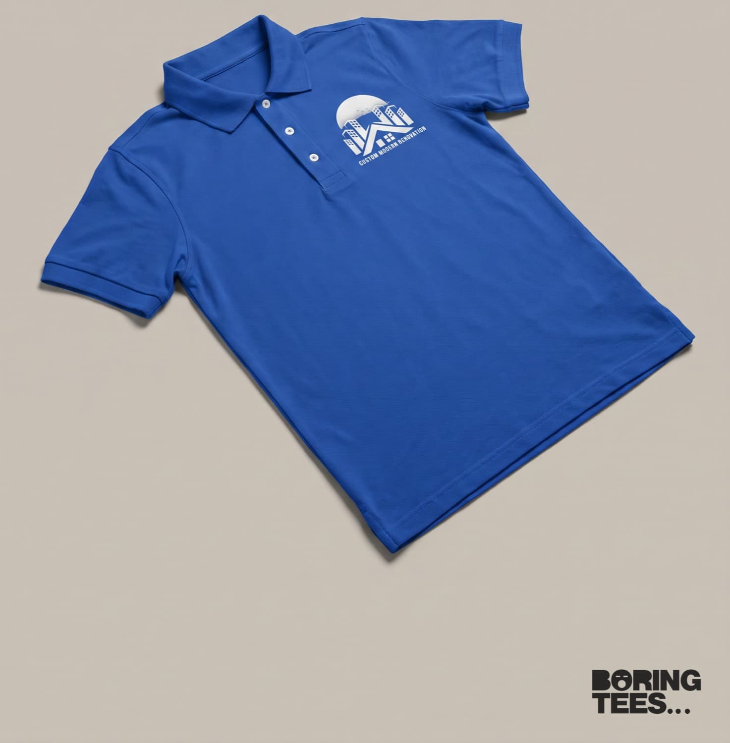 Royal blue polo with a small white Custom Modern Renovation logo on the left chest
