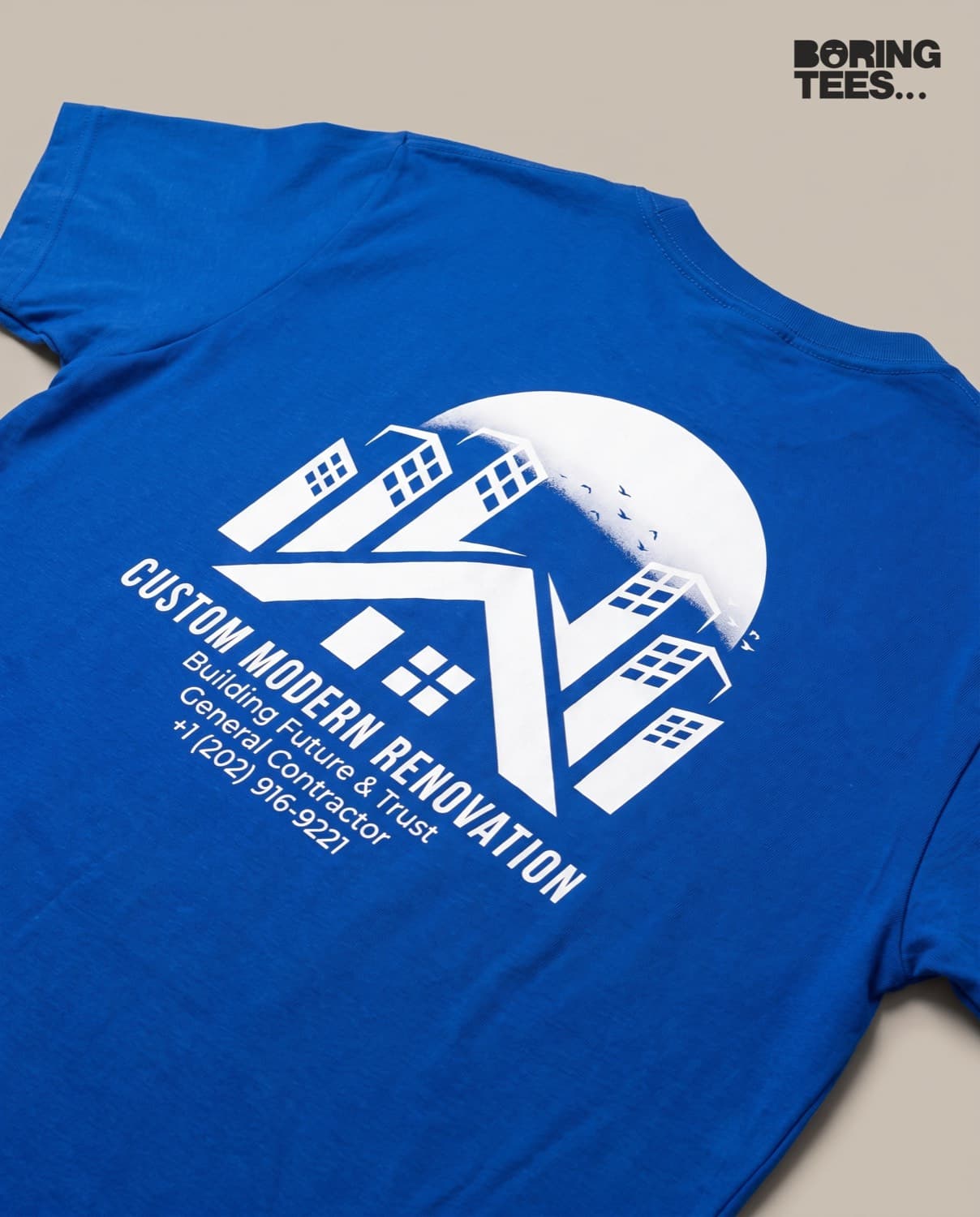 Royal blue tee showing the same white Custom Modern Renovation logo printed across the back