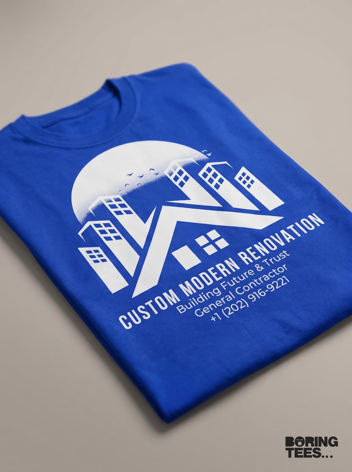 Royal blue tee with a large white Custom Modern Renovation logo, tagline and phone number printed on the front