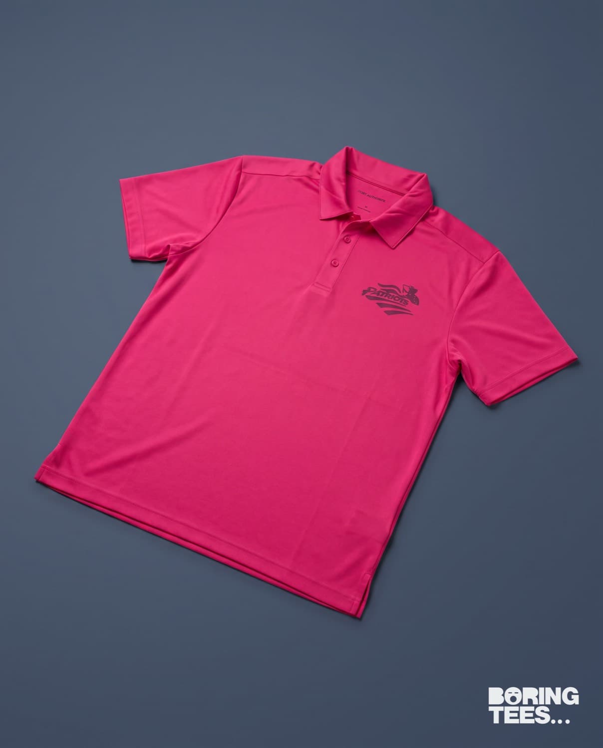 Hot pink polo with a tonal embroidered eagle crest on the left chest